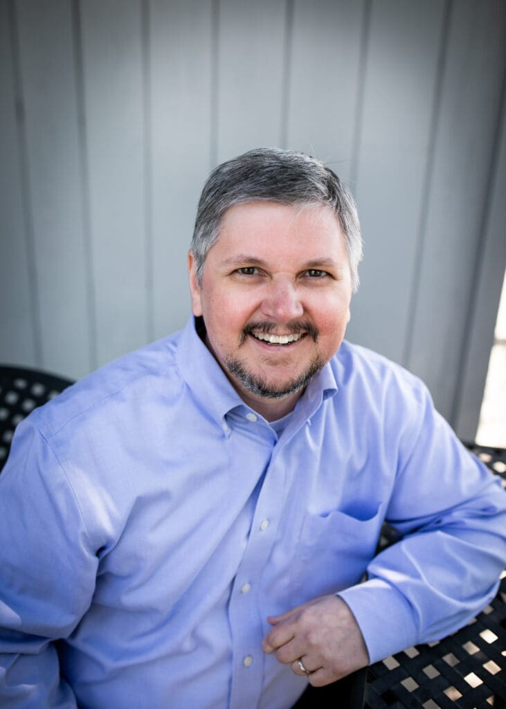 Tom Malesic posing outdoors.